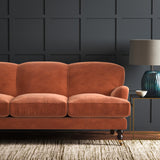 Orange eco velvet upholstery fabric on a sofa