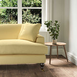 A yellow stain resistant woven fabric on an armchair.