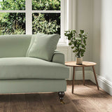 A green stain resistant woven fabric on an armchair.