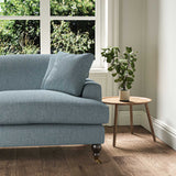 A blue stain resistant woven fabric on an armchair.