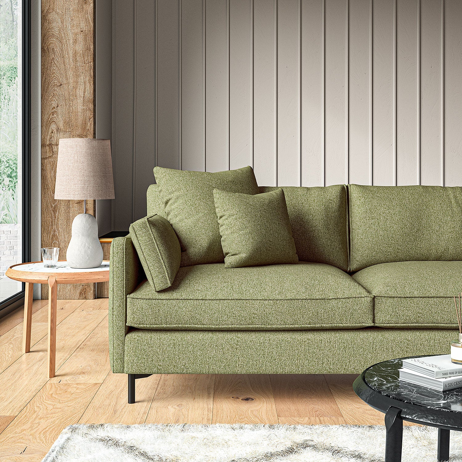 Sofa covered in a boucle fabric in Winter Moss