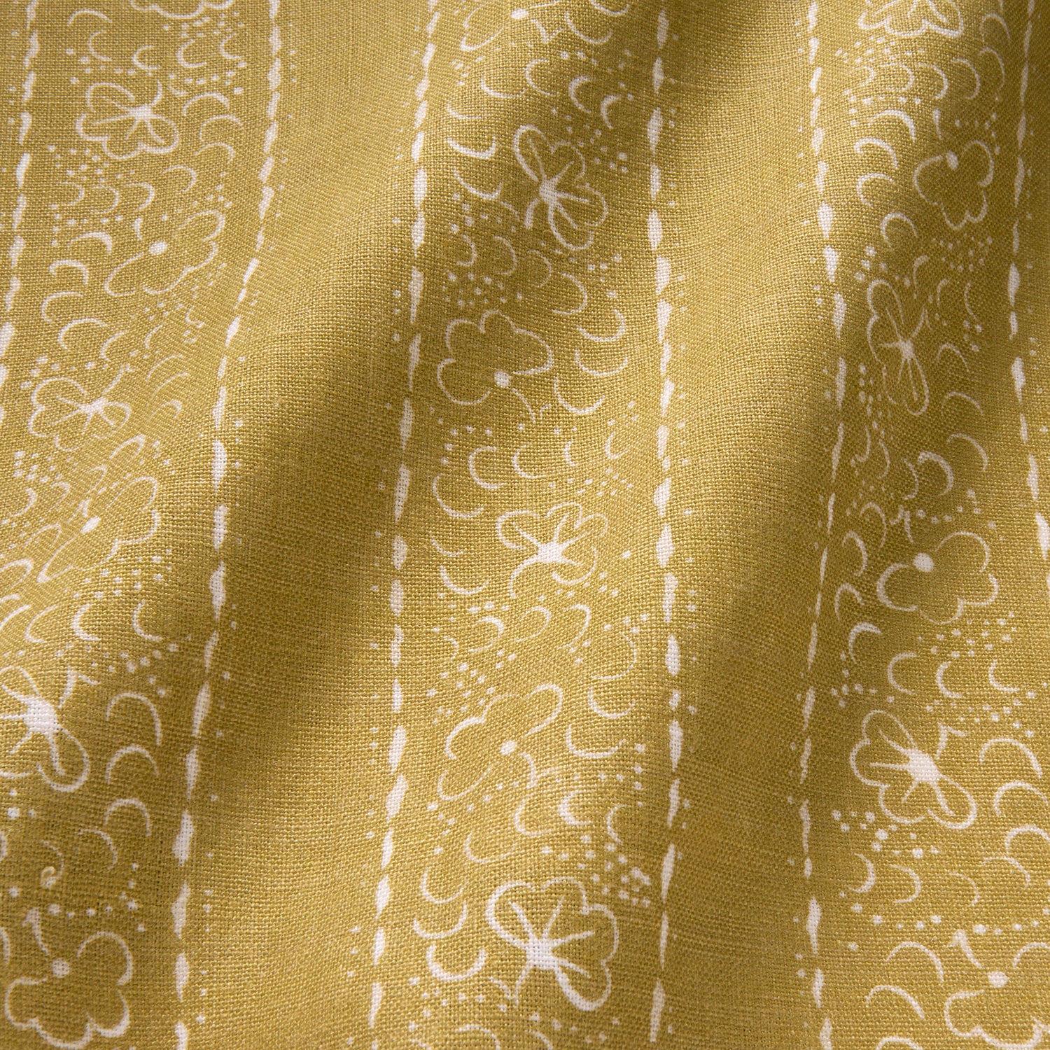 Printed linen fabric sample – a delicate pattern of moons and star-like dots in yellow and cream