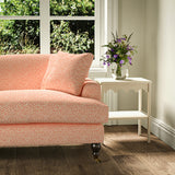 Printed linen fabric – a handy block print pattern in red and cream – on a sofa