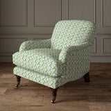 Printed linen fabric - a contemporary lattice design in green, blue, cream and white – on an armchair