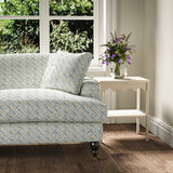 Printed linen fabric - a contemporary lattice design in blue, cream and white – on a sofa