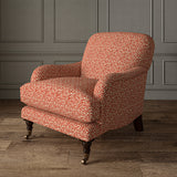 Printed linen fabric – damask-style pattern in red and cream – on an armchair