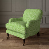 Printed linen fabric – damask-style pattern in green and cream – on an armchair
