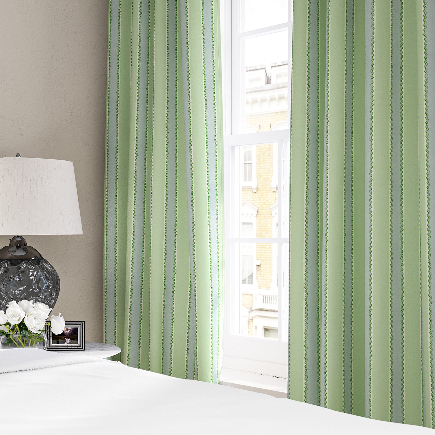 Linen curtains with a bold blocks of colour in this inviting stripe are softened with a painterly finish in blue, green and white