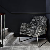 Luxurious printed velvet featuring a scenic/semi tropical design on a chair