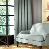 Living room featuring a sofa and curtains in a plain baby blue eco-friendly fabric
