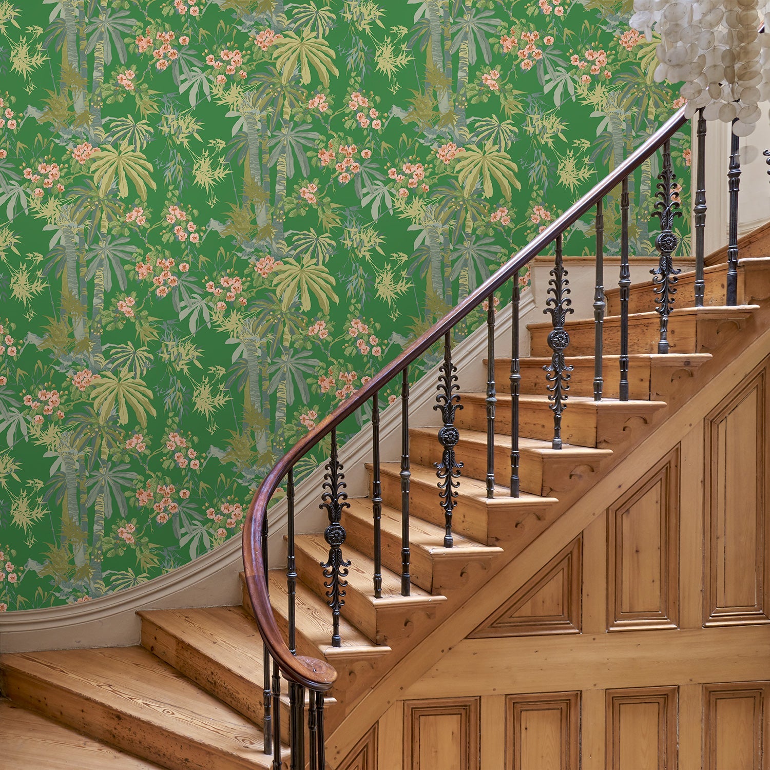Hallway with a tropical wallpaper in emerald green with exotic, floral blossoms intertwined with bamboo.