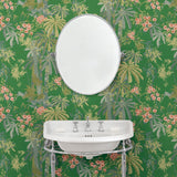 Bathroom with a tropical wallpaper in emerald green with exotic, floral blossoms intertwined with bamboo.