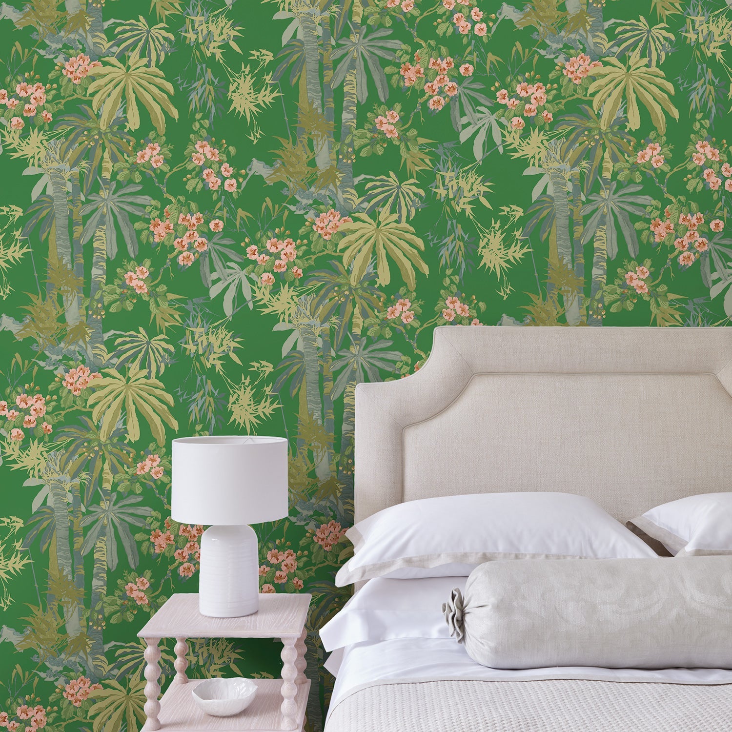 Bedroom with a tropical wallpaper in emerald green with exotic, floral blossoms intertwined with bamboo.