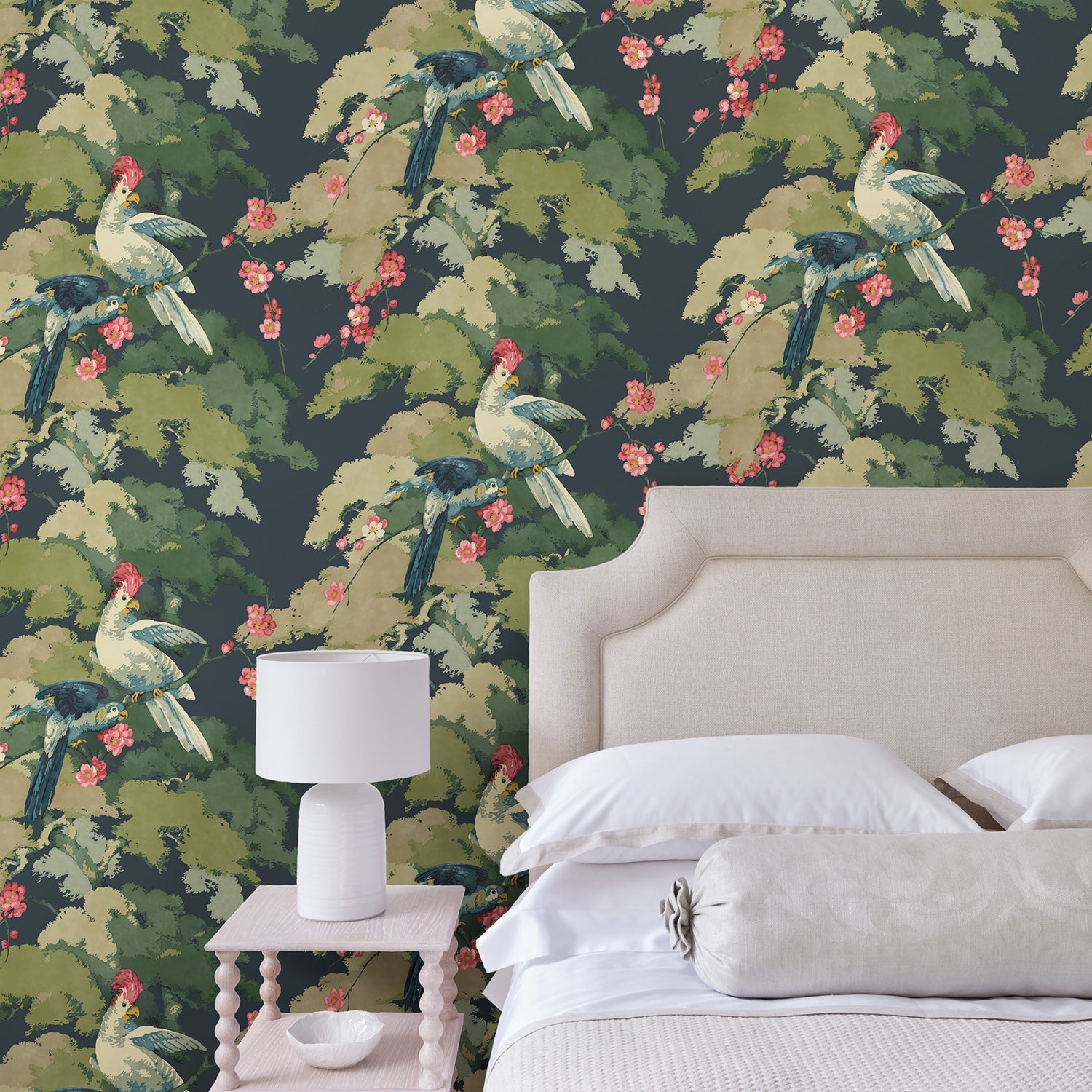 Bedroom showcasing a tropical wallpaper featuring parakeets and pretty blossom. 