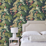 Bedroom showcasing a tropical wallpaper featuring parakeets and pretty blossom. 