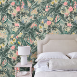 Bedroom with tropical wallpaper featuring a lush design.