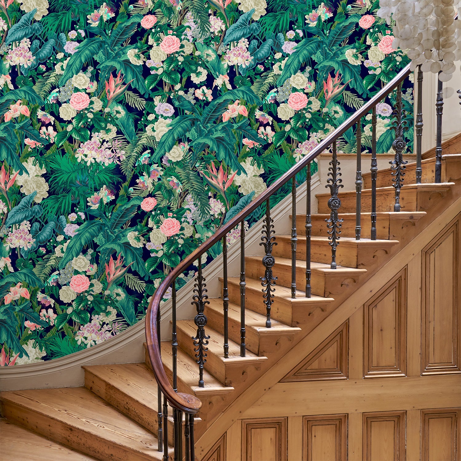 Hallway featuring a smart, tropical wallpaper.