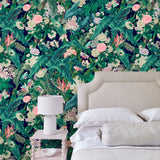 Bedroom featuring a smart, tropical wallpaper.