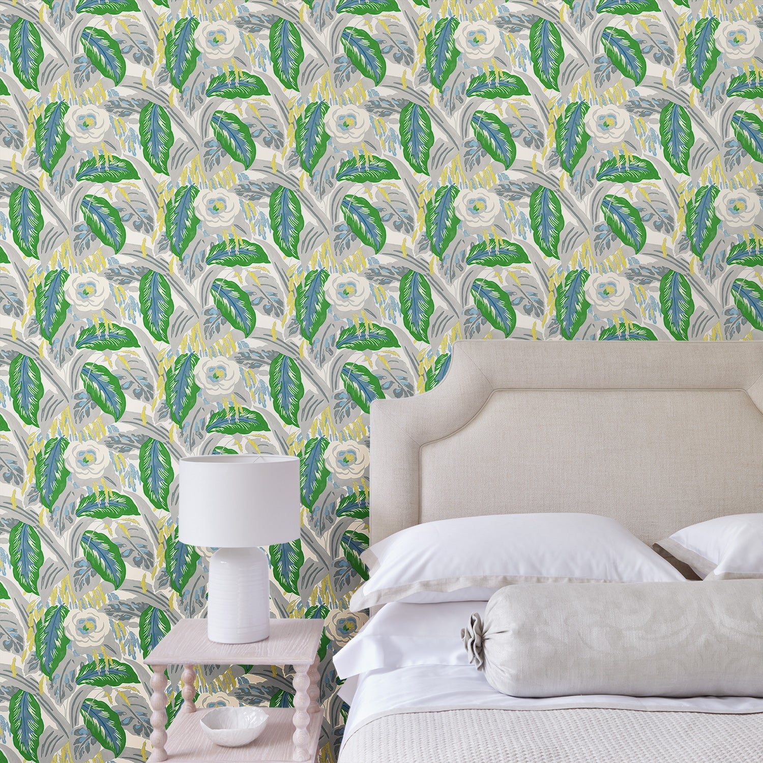 Bedroom with a green floral wallpaper.