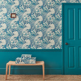 Sitting room with stylish abstract wallpaper featuring dramatic, undulating waves.