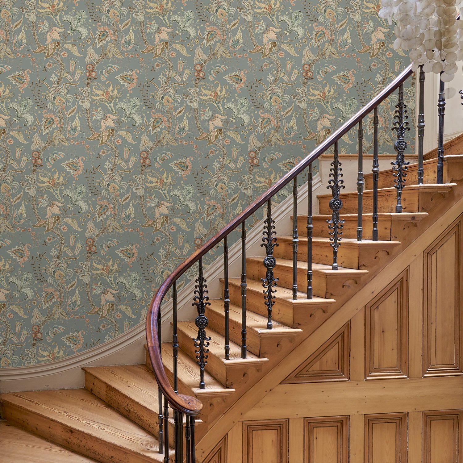 Hallway with a tropical wallpaper in a smart neutral showcasing beautiful botanicals and butterflies.