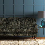 A printed velvet fabric showcasing stylised wisteria in green and brown on a sofa