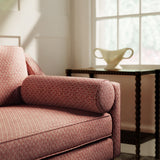 Sofa upholstered in a red and neutral printed linen fabric with a geometric pattern