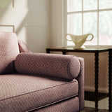Sofa upholstered in a red and neutral printed linen fabric with a geometric pattern